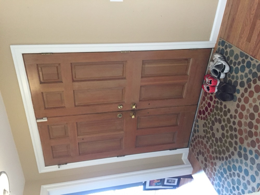 Scuffed and faded oak double entry doors