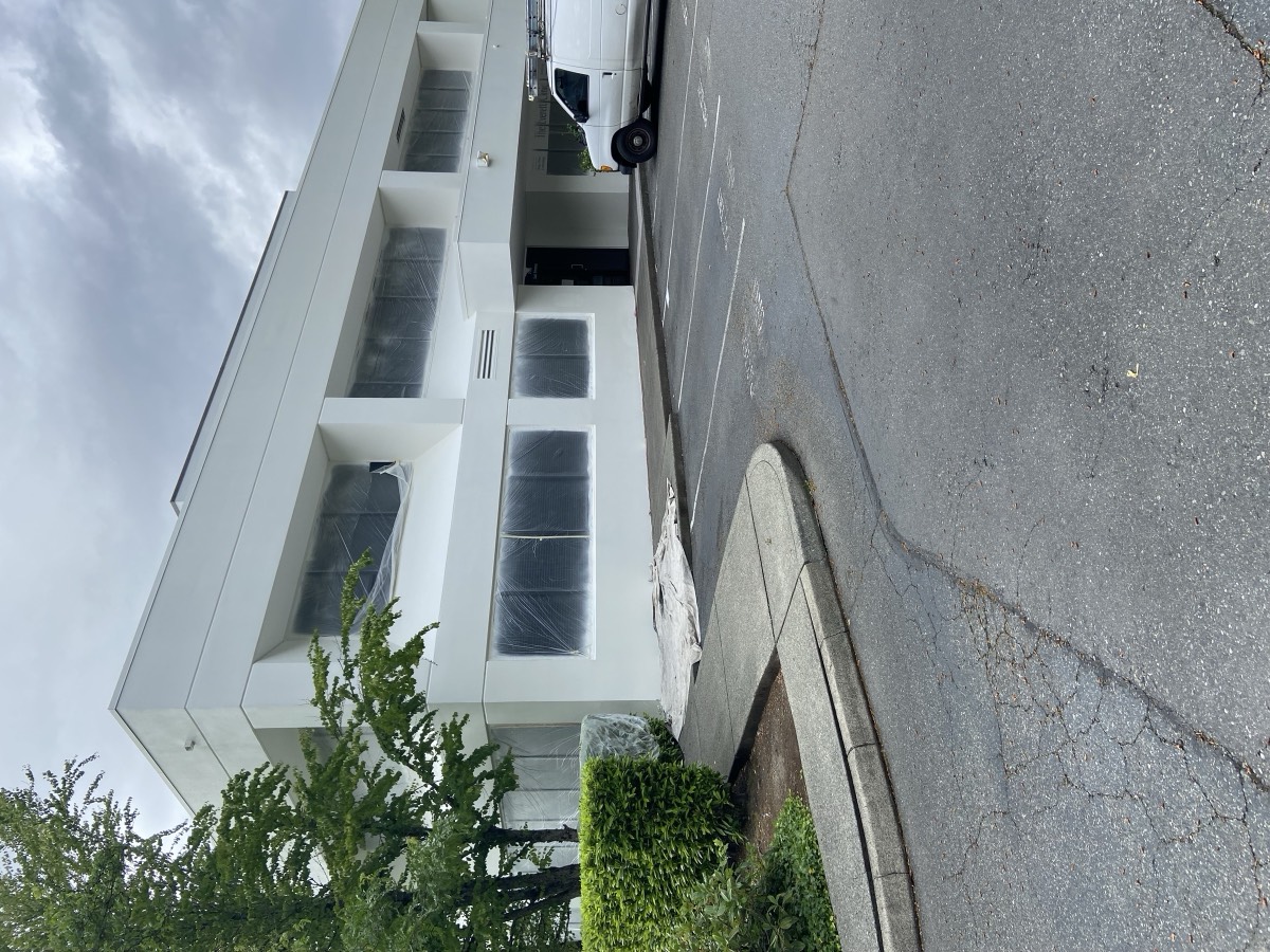 Commercial office building exterior repainted in white